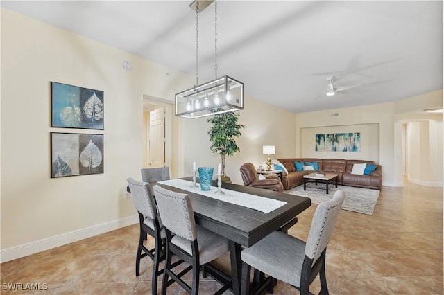 dining room with baseboards, a ceiling fan, and light tile patterned flooring