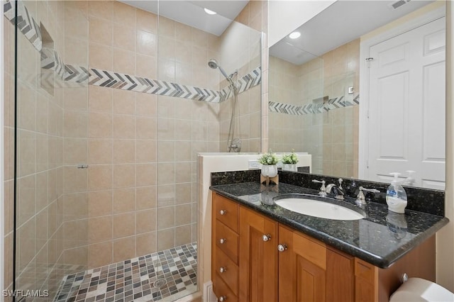 full bath with a walk in shower, visible vents, and vanity