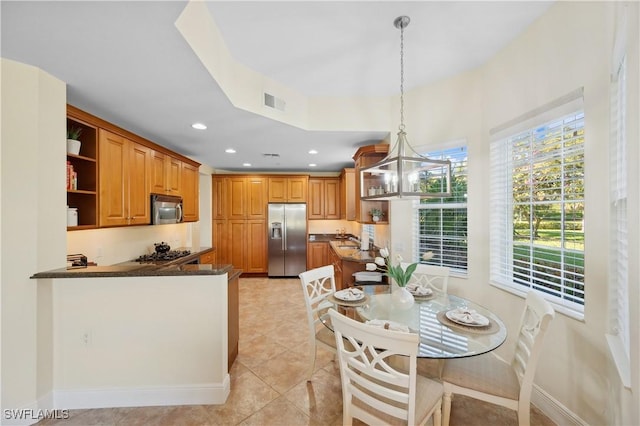 kitchen with open shelves, stainless steel appliances, dark countertops, visible vents, and an inviting chandelier