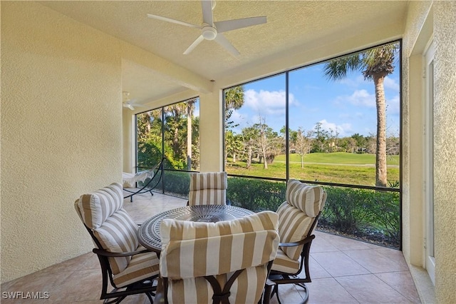 sunroom / solarium with plenty of natural light and a ceiling fan