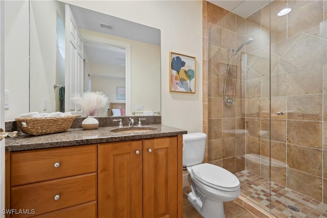 full bath with visible vents, toilet, a shower stall, vanity, and tile patterned flooring