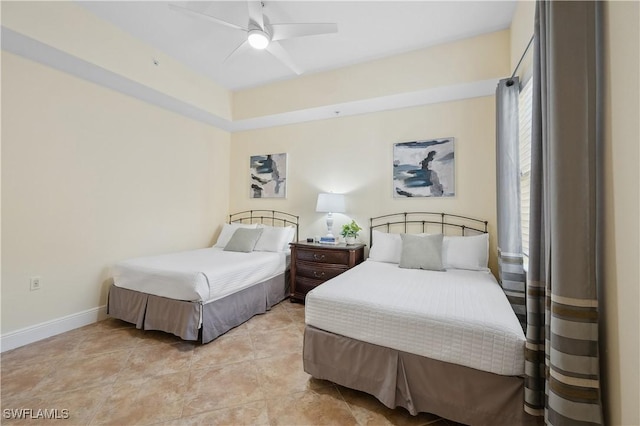 bedroom with a ceiling fan and baseboards