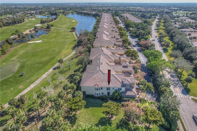 birds eye view of property with a water view and view of golf course