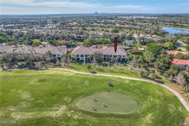 drone / aerial view featuring view of golf course and a water view