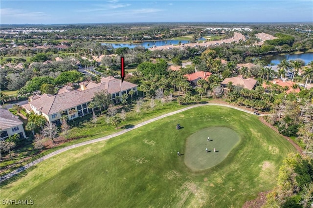 aerial view with golf course view and a water view