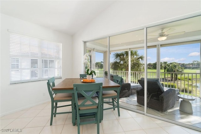 dining space featuring light tile patterned floors, baseboards, ceiling fan, and lofted ceiling