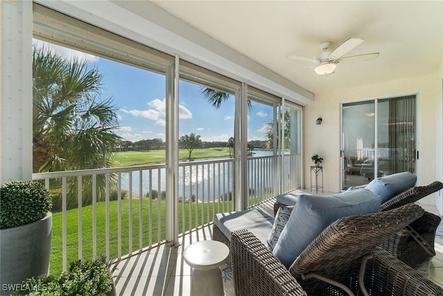 sunroom featuring a water view