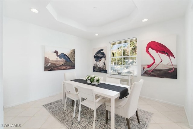 dining space featuring recessed lighting, light tile patterned floors, and a raised ceiling