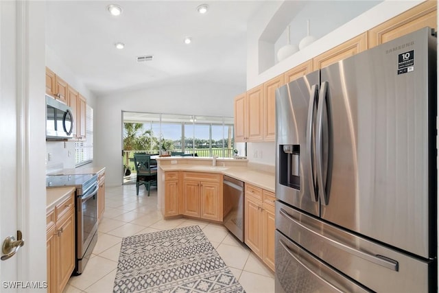 kitchen with visible vents, light countertops, lofted ceiling, and stainless steel appliances
