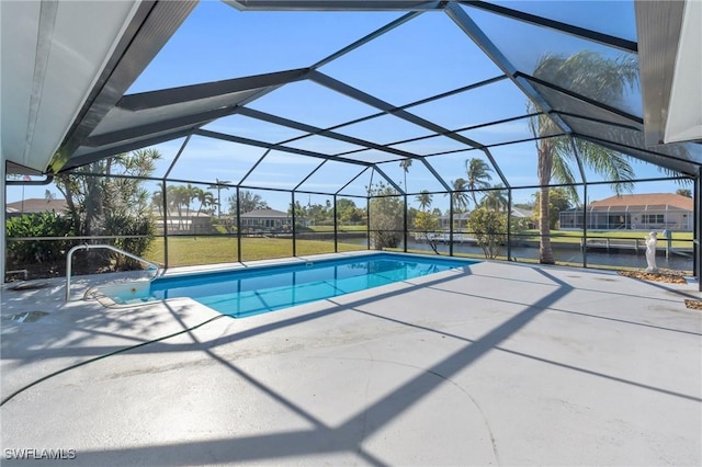 view of swimming pool featuring a lanai, a patio area, and a lawn