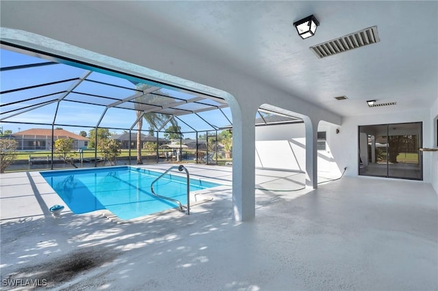 view of swimming pool featuring a lanai and a patio area