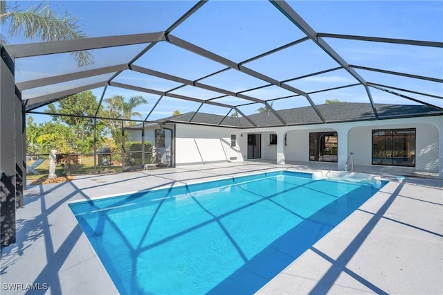 view of pool with a lanai and a patio