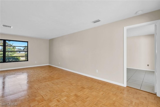 unfurnished room with light parquet flooring