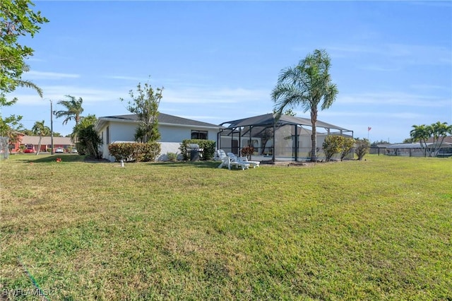 view of yard featuring glass enclosure