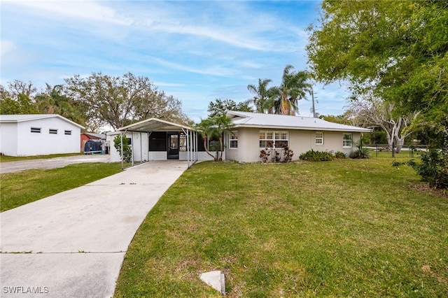 ranch-style house featuring a detached carport, concrete driveway, fence, and a front lawn