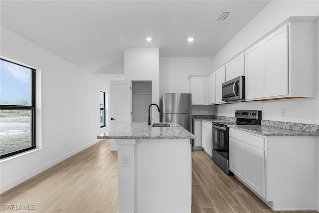 816 Gen D Macarthur Ave, Labelle, FL 33935 - kitchen with appliances with stainless steel finishes, a sink, a center island with sink, light stone counters, and recessed lighting