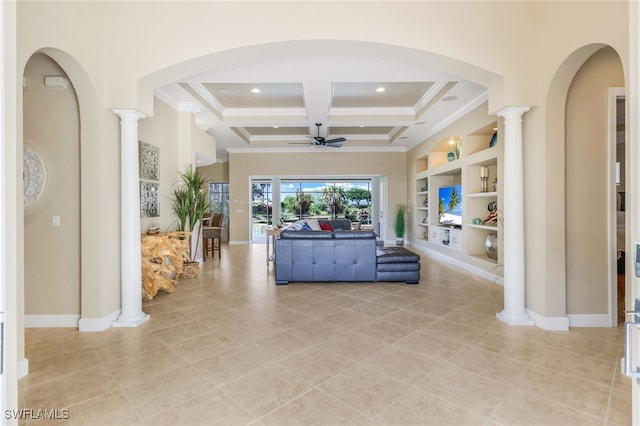 unfurnished living room with coffered ceiling, built in shelves, beamed ceiling, ceiling fan, and ornate columns