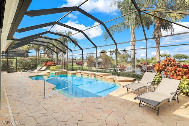 view of swimming pool featuring an in ground hot tub, a patio, and a lanai