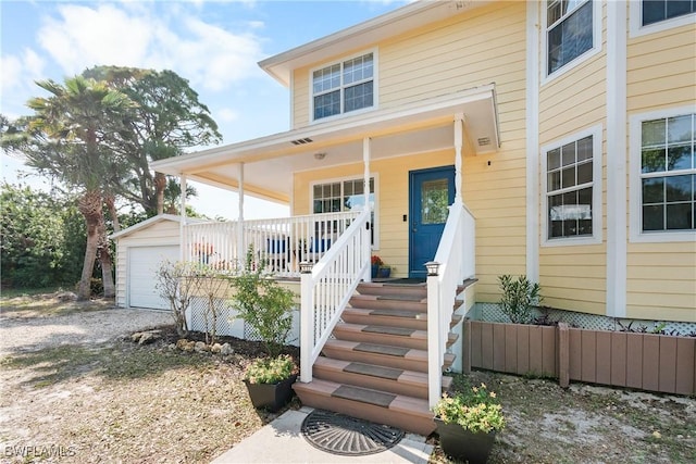 exterior space with a porch and a garage