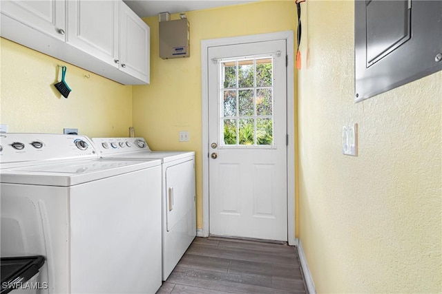 clothes washing area with wood finished floors, baseboards, cabinet space, a textured wall, and independent washer and dryer