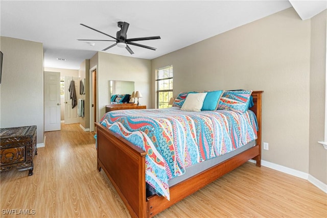 bedroom featuring light wood-type flooring, baseboards, and ceiling fan