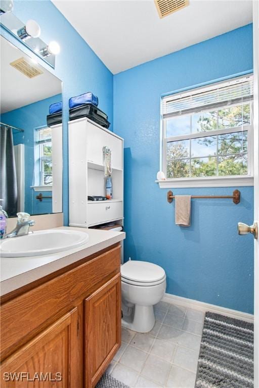 full bath with vanity, toilet, baseboards, and visible vents