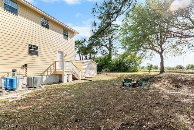 view of yard featuring cooling unit and an outdoor structure