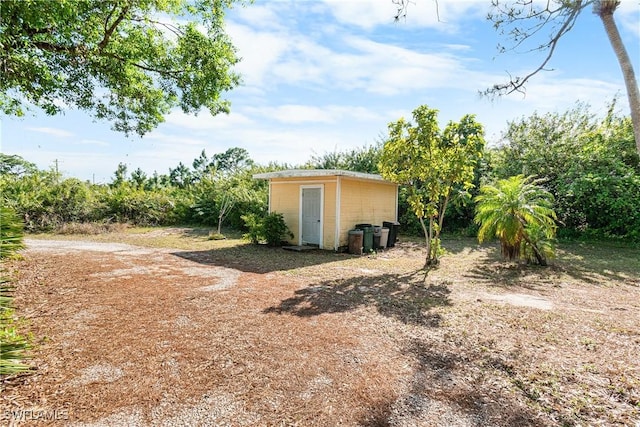 view of yard with an outbuilding and a storage shed