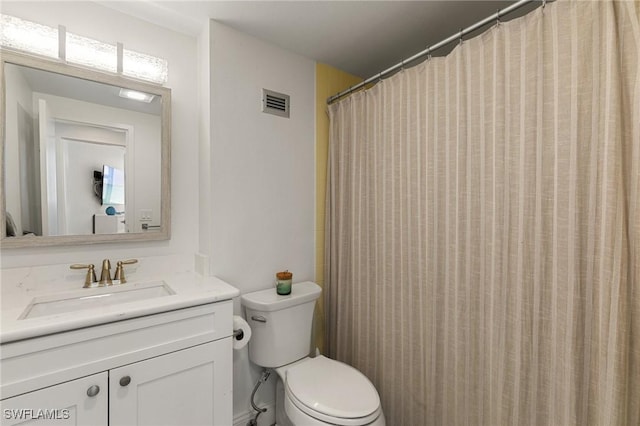 bathroom with vanity, curtained shower, and toilet