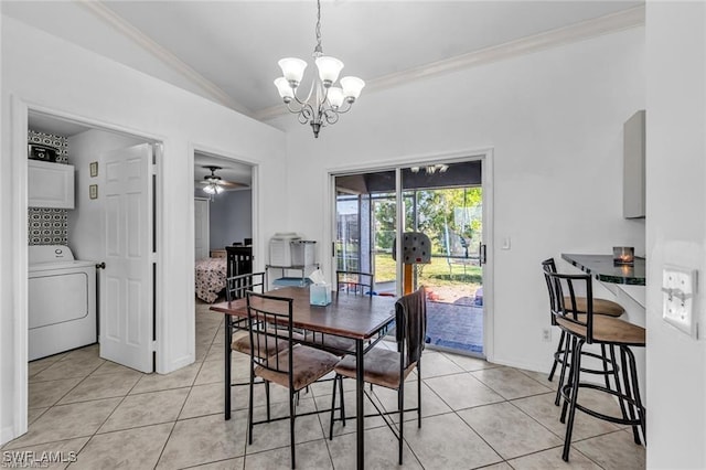 dining space featuring ceiling fan with notable chandelier, washer / dryer, lofted ceiling, ornamental molding, and light tile patterned floors