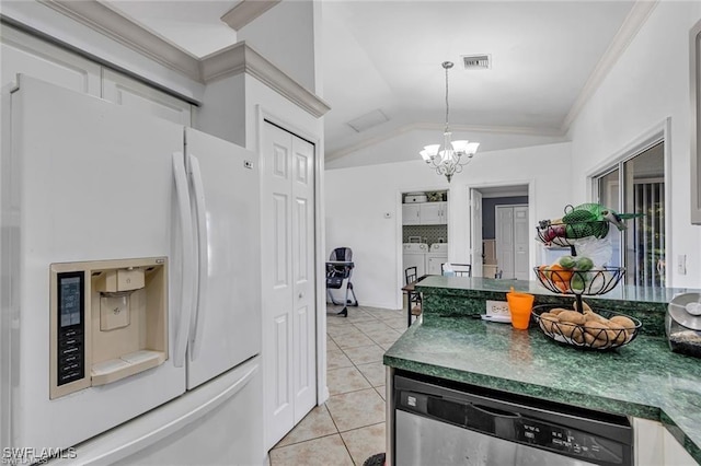 kitchen featuring pendant lighting, separate washer and dryer, white fridge with ice dispenser, stainless steel dishwasher, and light tile patterned floors