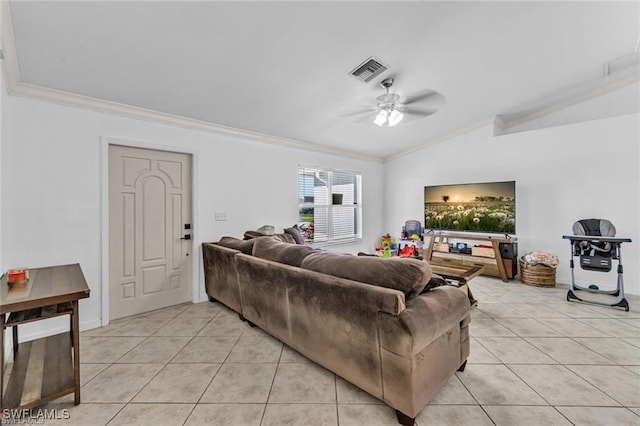 living room with light tile patterned flooring, lofted ceiling, ornamental molding, and ceiling fan