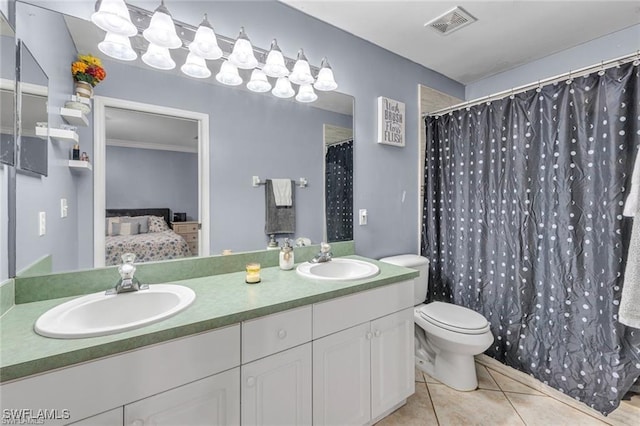 bathroom featuring tile patterned flooring, vanity, and toilet