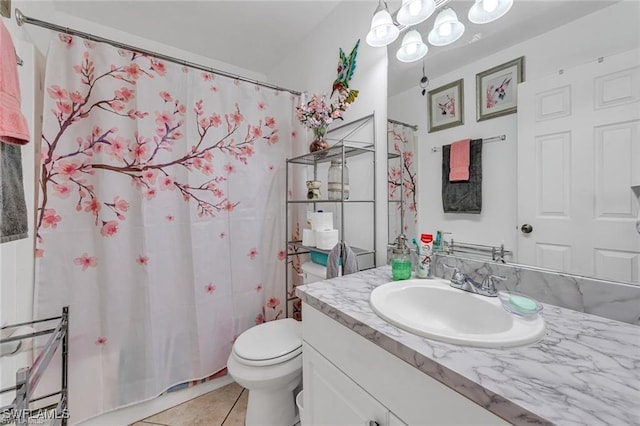 bathroom featuring tile patterned flooring, vanity, curtained shower, and toilet