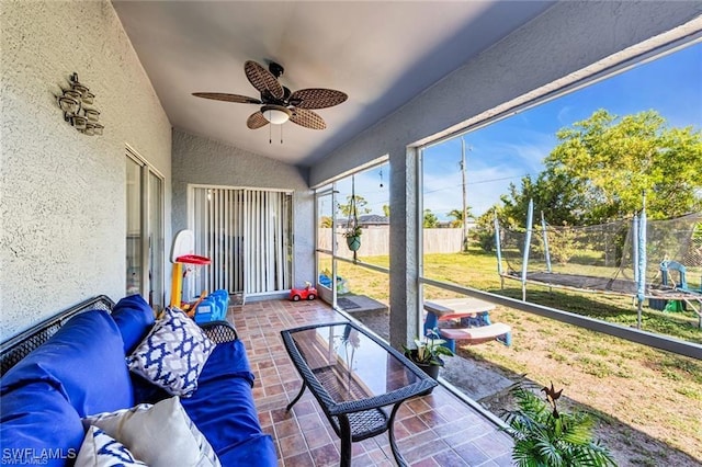 sunroom featuring lofted ceiling and ceiling fan