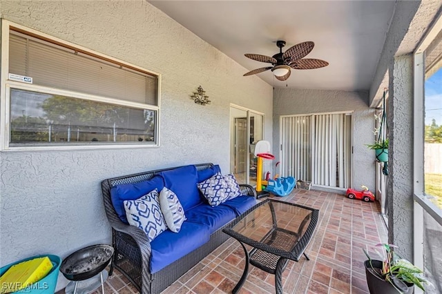 sunroom featuring ceiling fan and lofted ceiling