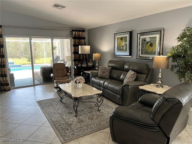 living room featuring visible vents, vaulted ceiling, and light tile patterned flooring