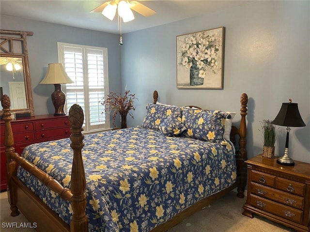 bedroom featuring light carpet and a ceiling fan