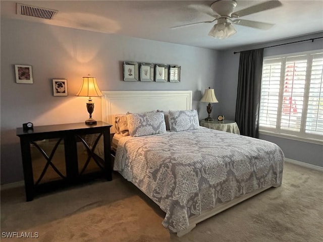 bedroom with a ceiling fan, baseboards, visible vents, and carpet flooring