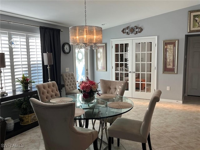 dining room with french doors, light tile patterned flooring, and a healthy amount of sunlight