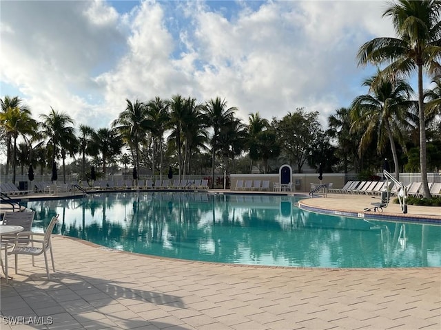 pool featuring a patio area and fence