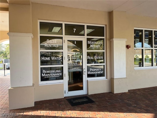 doorway to property with stucco siding