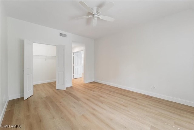 unfurnished bedroom with a closet, ceiling fan, and light wood-type flooring