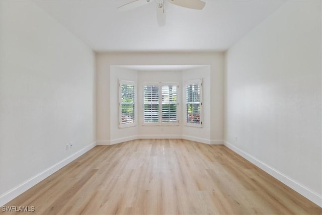 empty room featuring ceiling fan and light hardwood / wood-style flooring