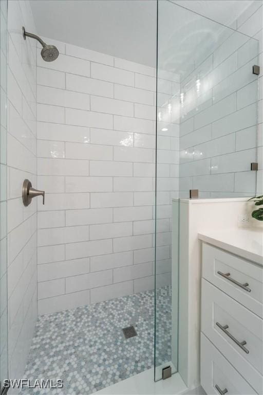 bathroom featuring vanity and a shower with door