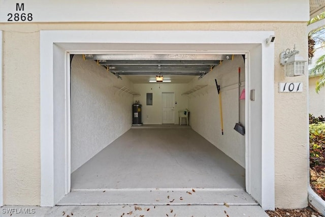 garage with a garage door opener, electric panel, and water heater