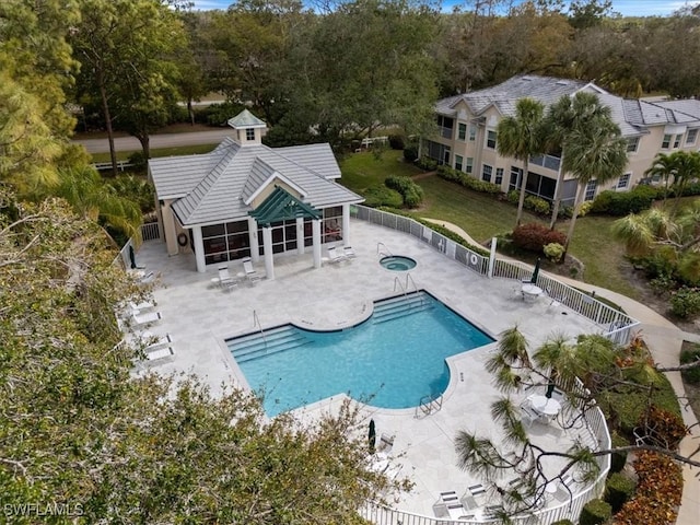 view of swimming pool featuring a hot tub and a patio