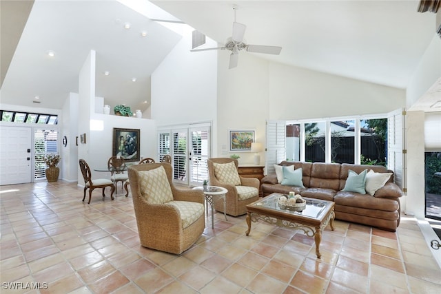 tiled living room with ceiling fan, high vaulted ceiling, and a healthy amount of sunlight