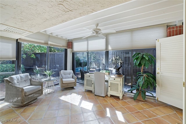 sunroom / solarium with beam ceiling and ceiling fan