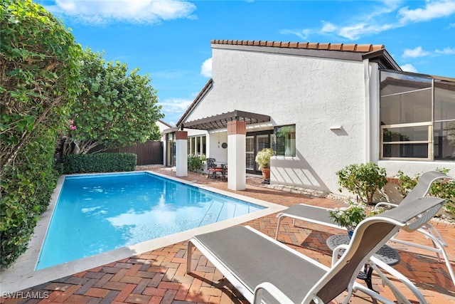 view of swimming pool with a patio and a pergola